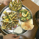 A plate of fried sardines, pita, olives, a cucumber and tomato salad, and a hungry boy. (Photo: David Silverman/Getty Images)